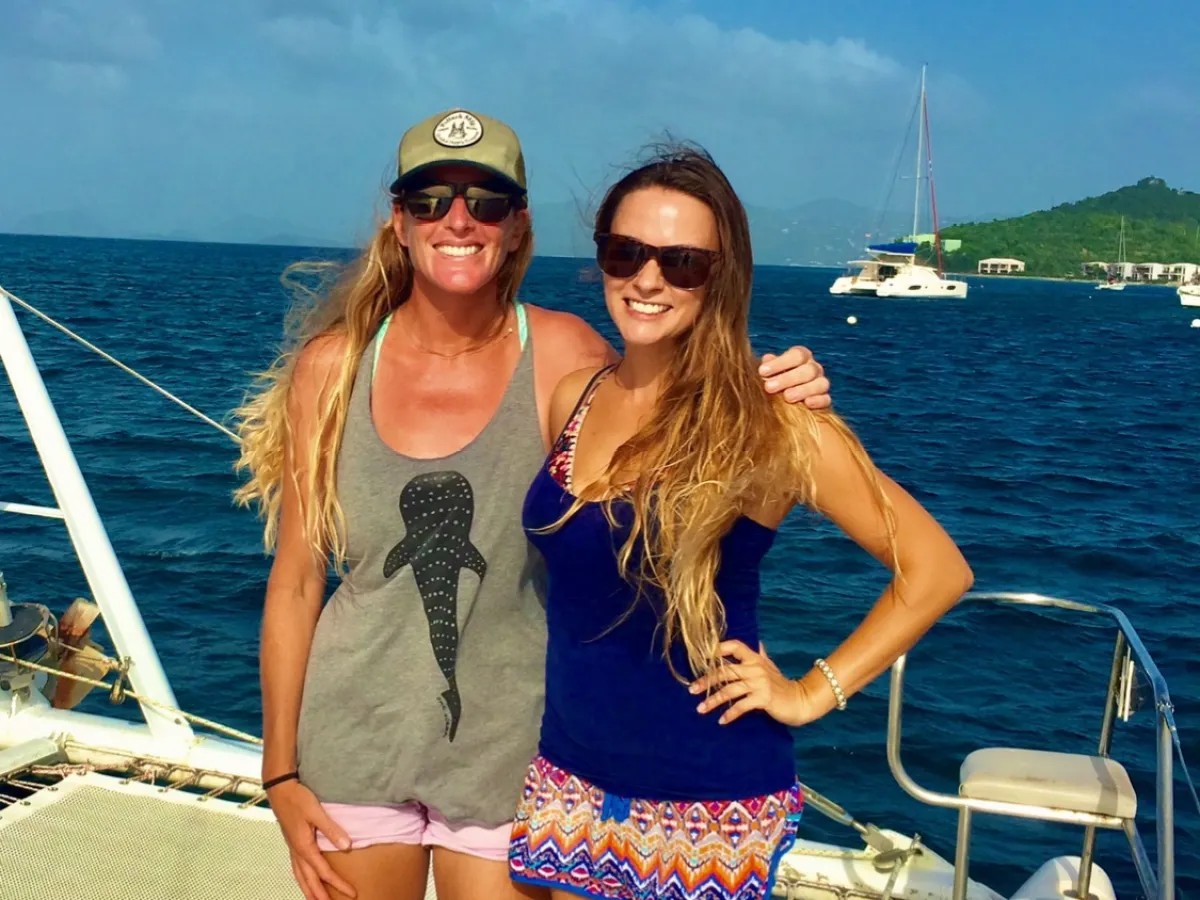 a woman sitting in a boat on a body of water