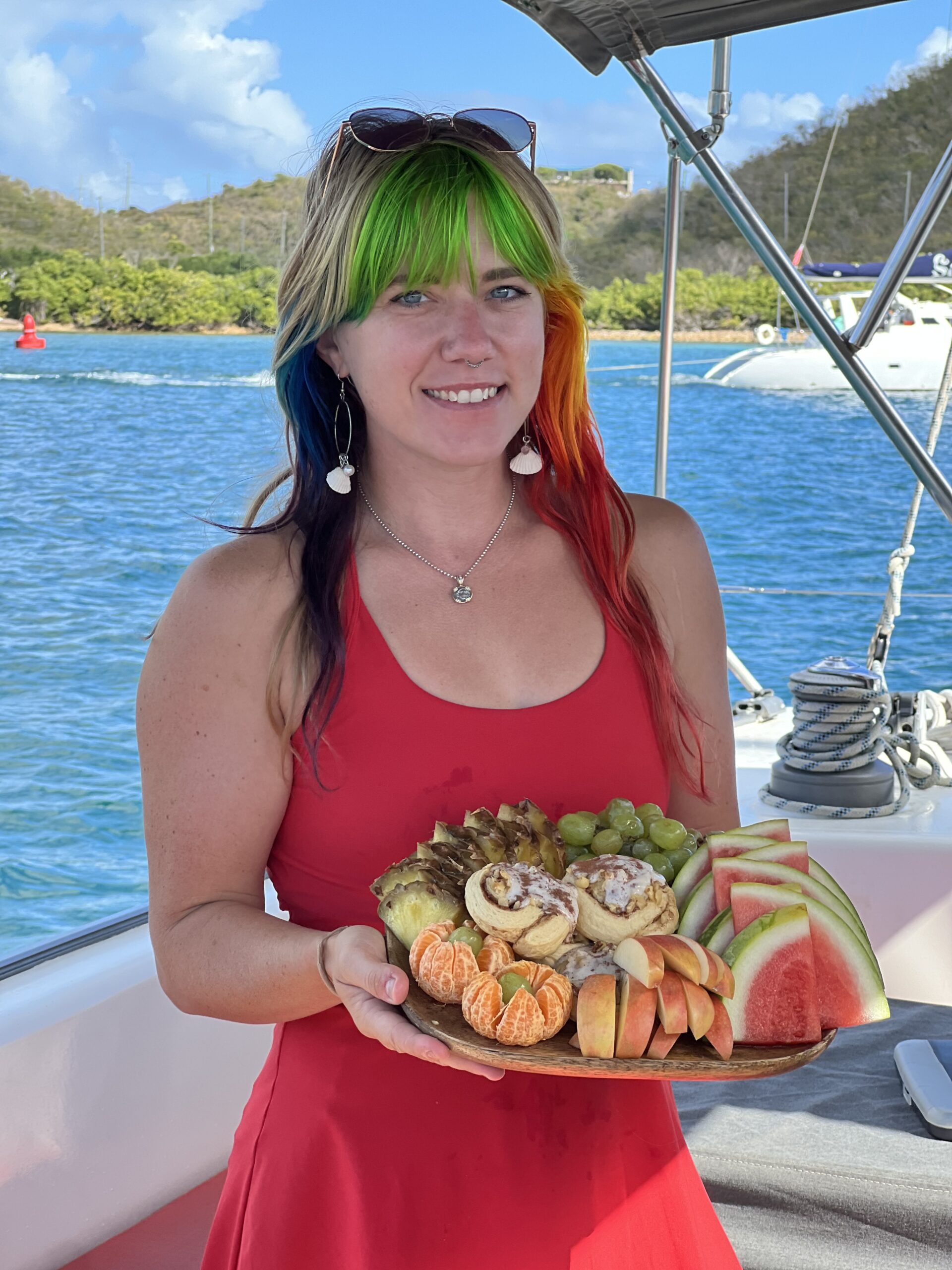 a woman standing in front of a body of water